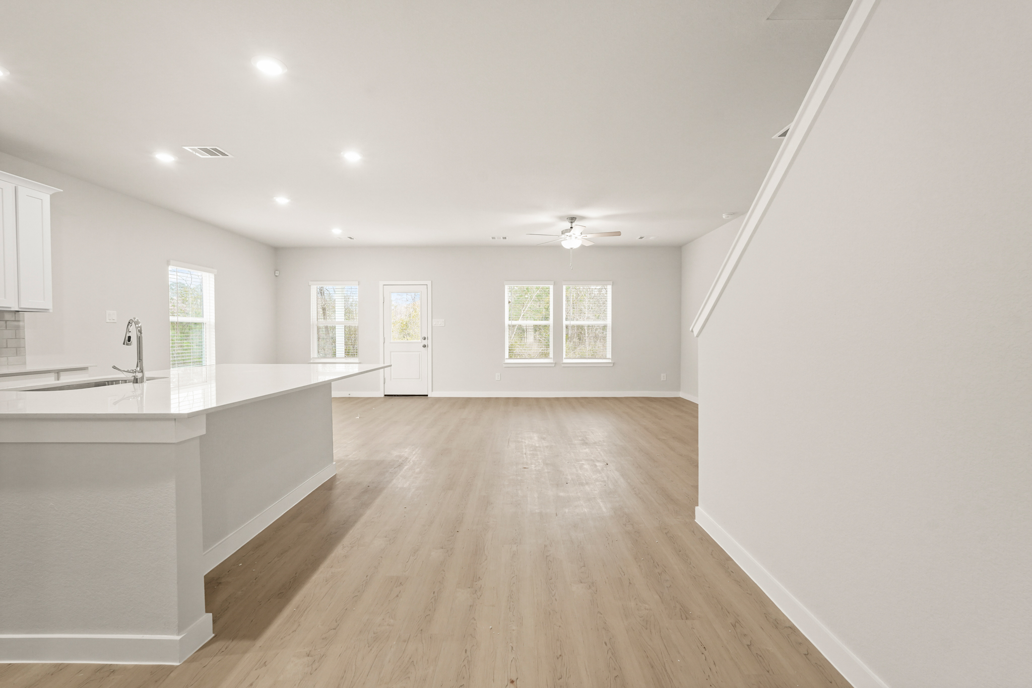 A large kitchen with white walls.