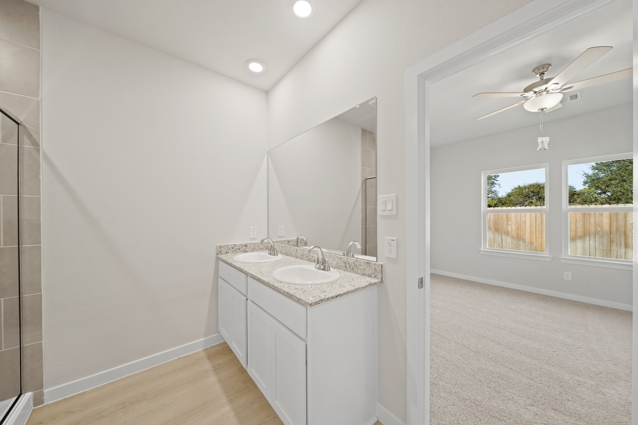 A bathroom with a large mirror.