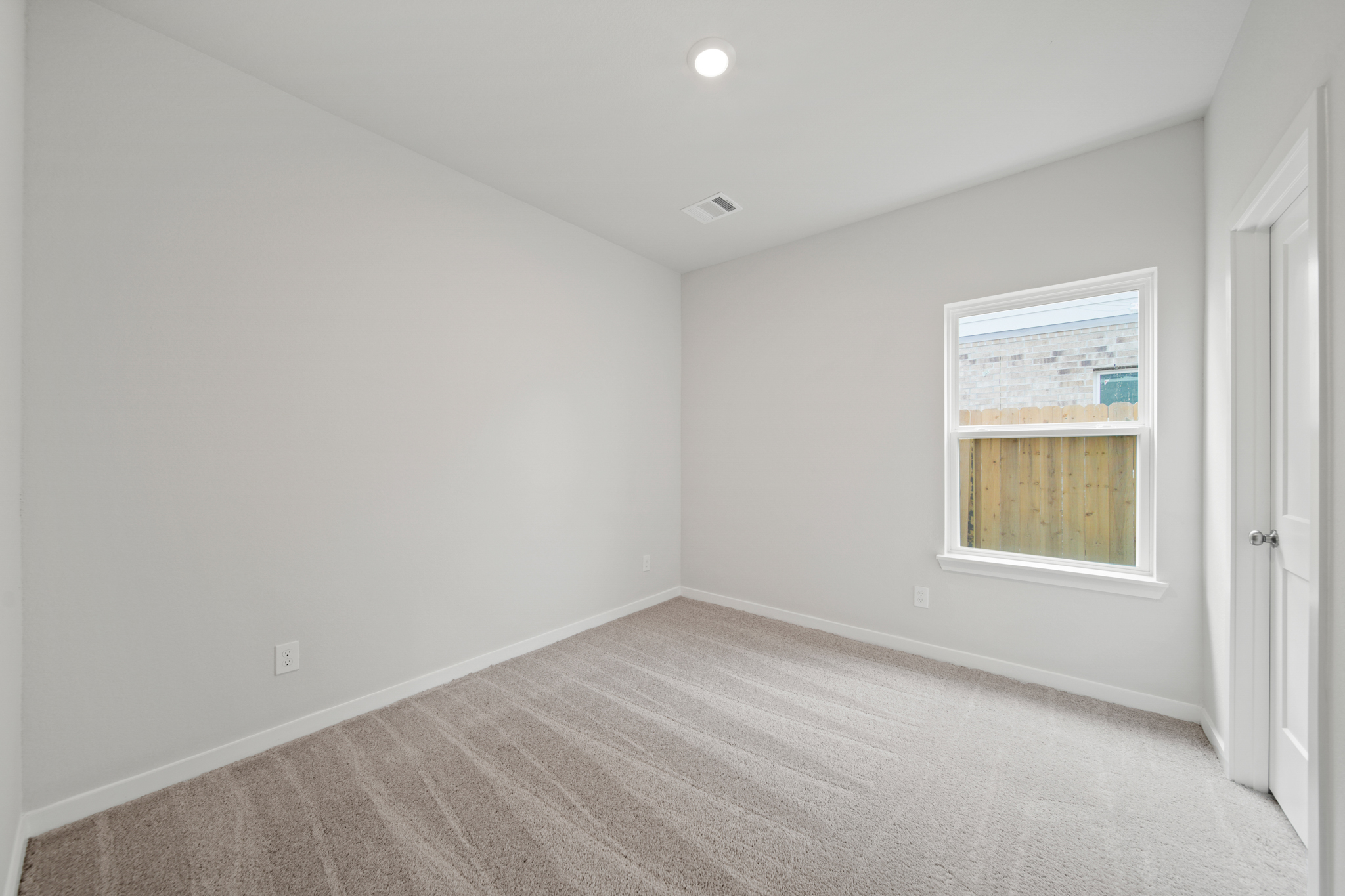 A room with a window and a door.