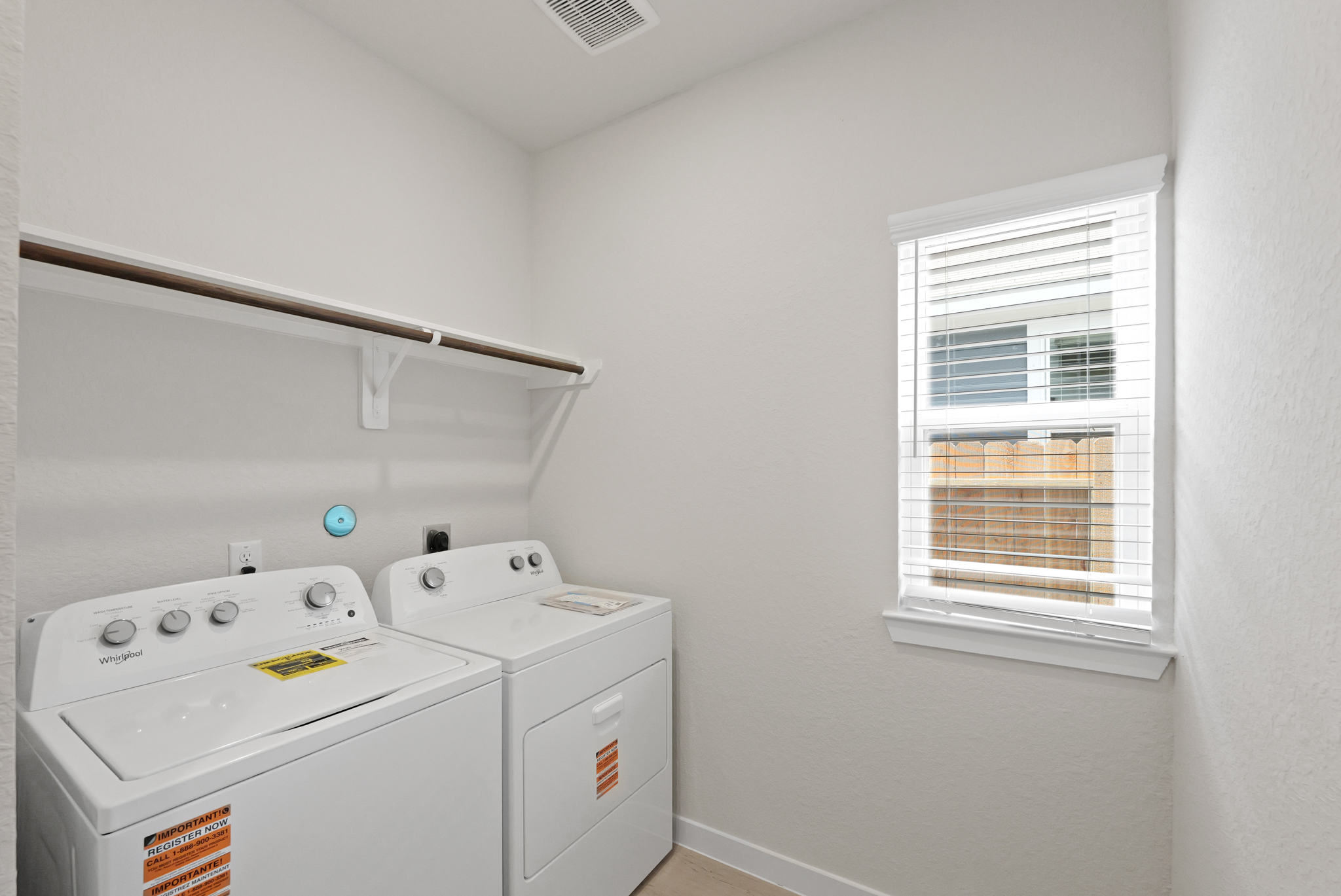 A laundry room with a washing machine.