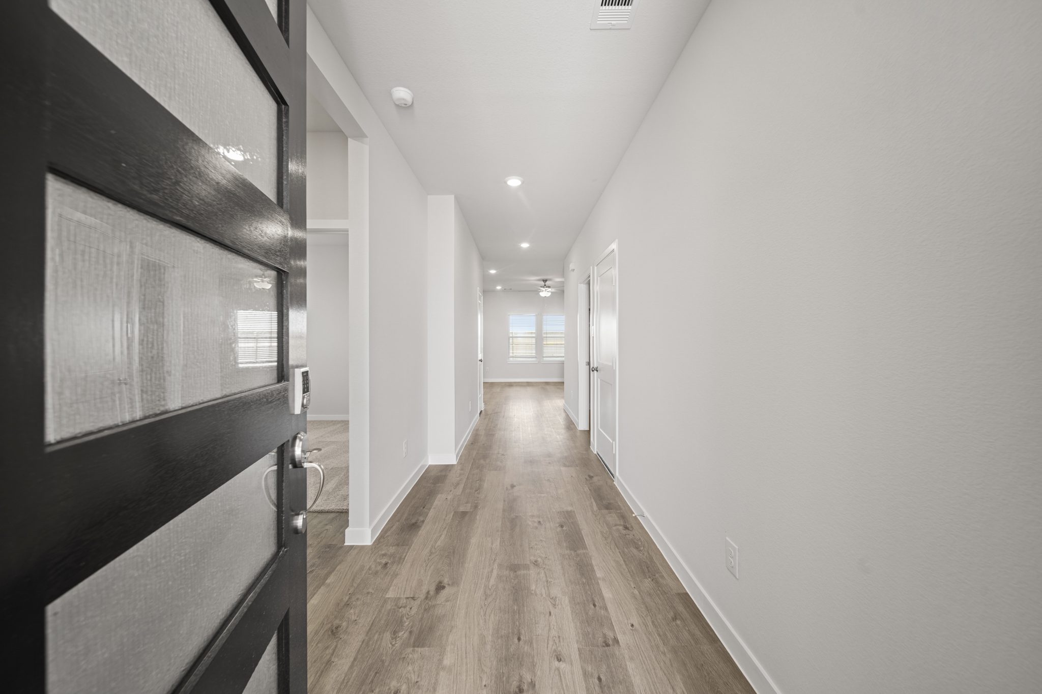 A hallway with white walls.