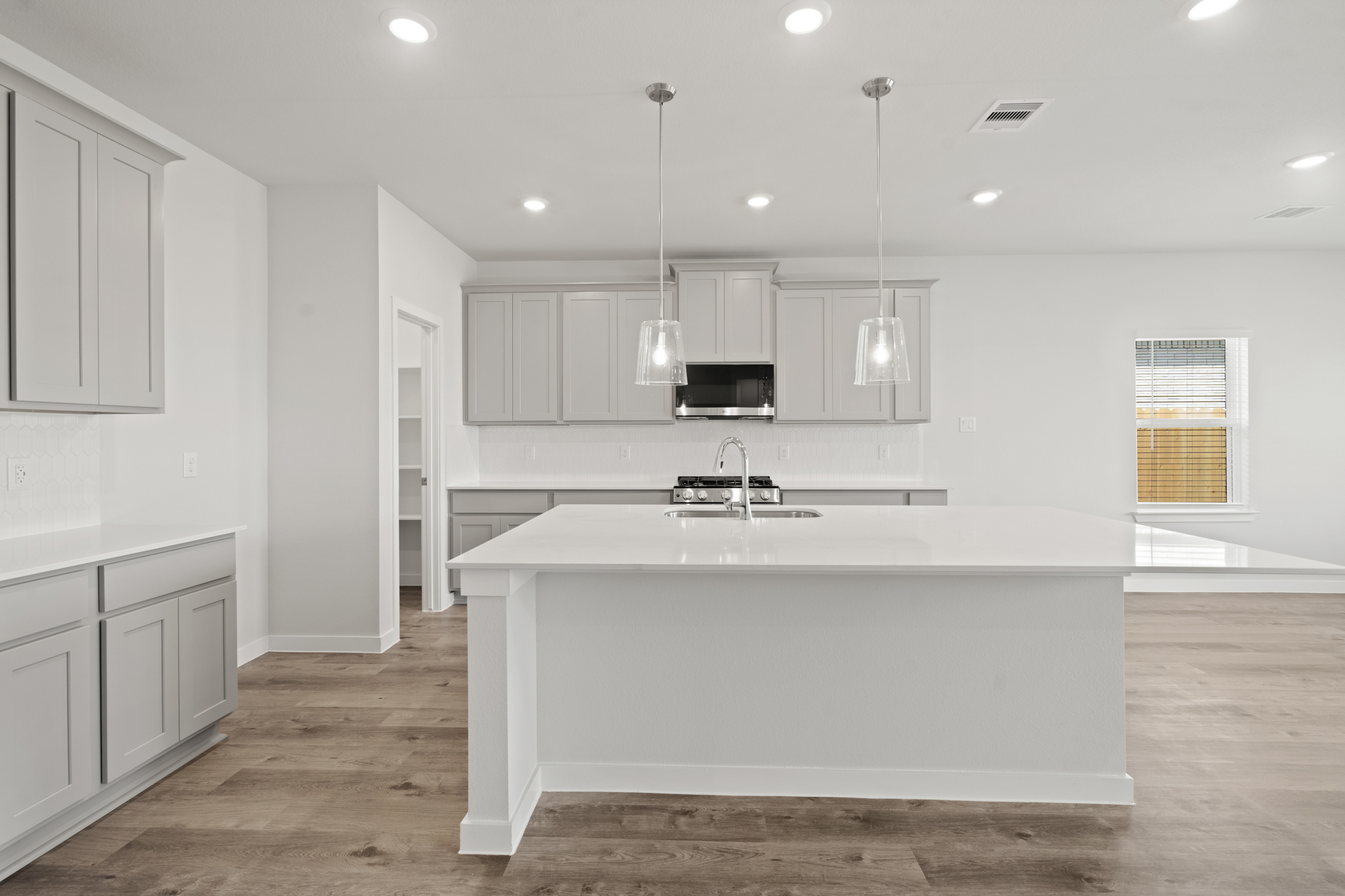 A kitchen with white cabinets.