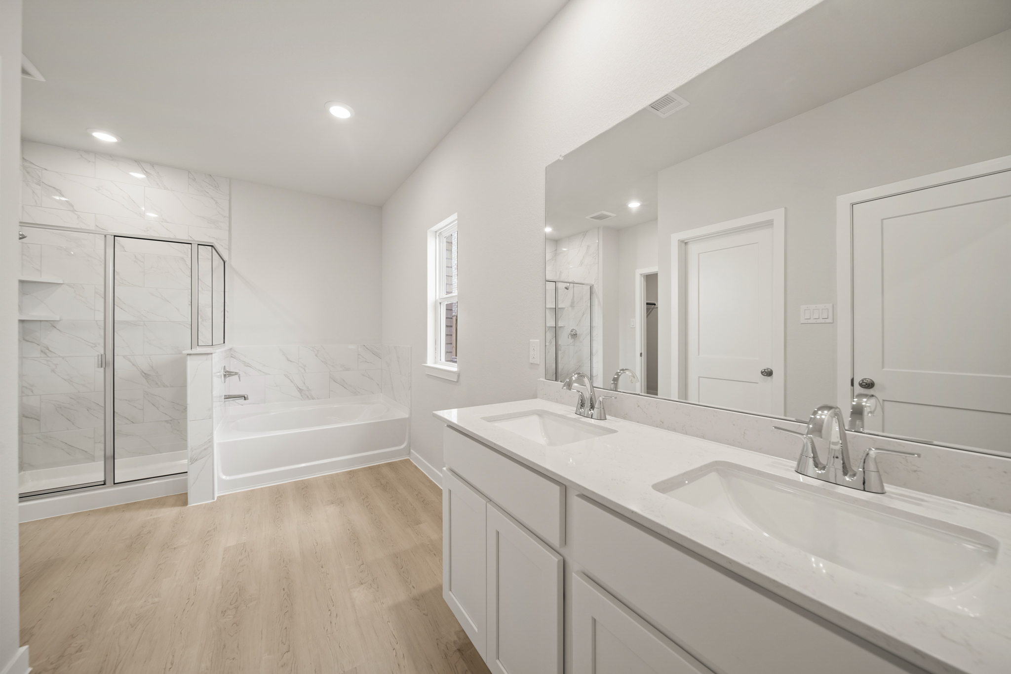 A bathroom with a tub sink and a shower.