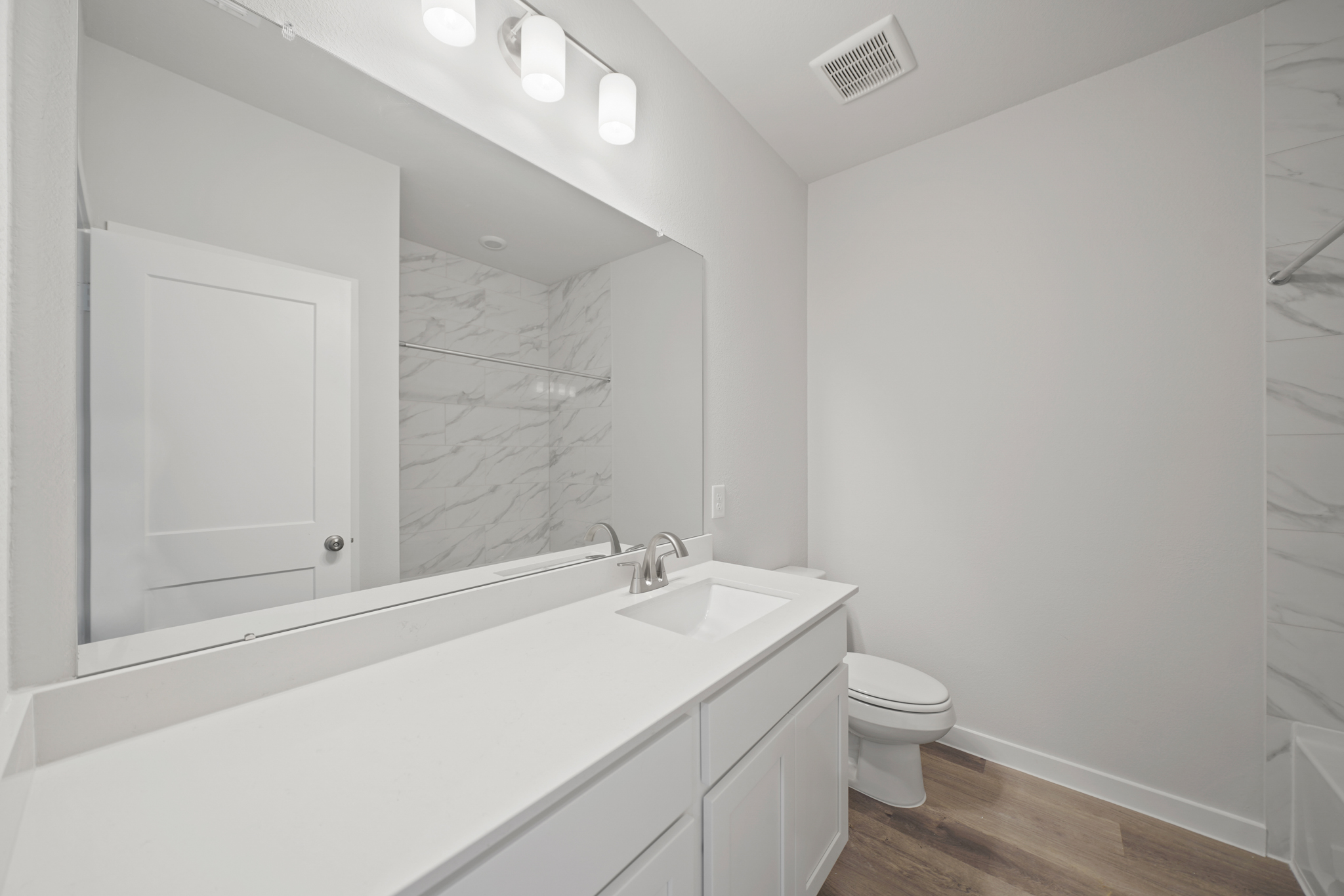 A bathroom with a tub sink and toilet.