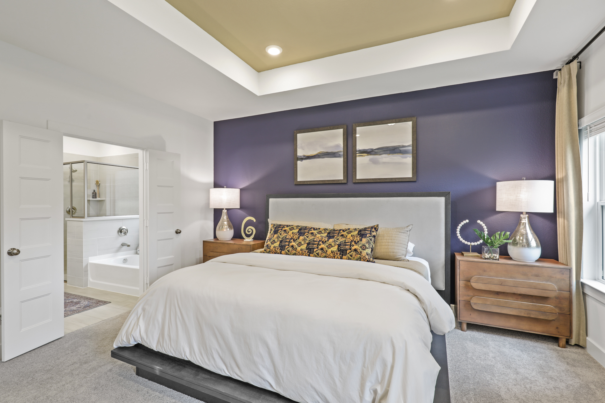 A bedroom with a bed and a mirror.