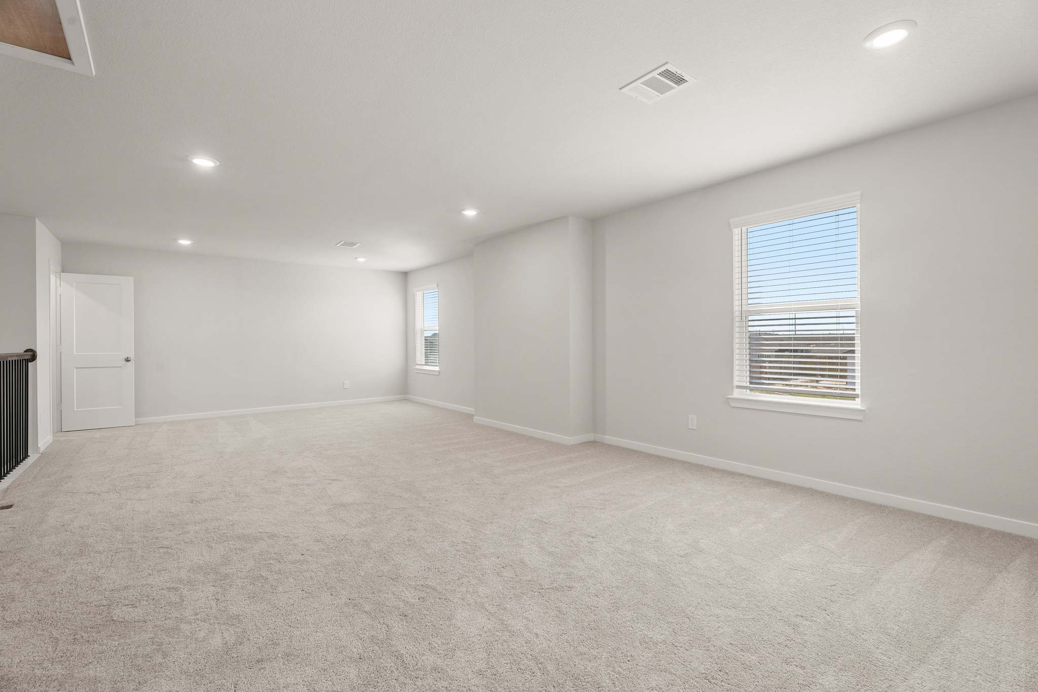 A room with a carpet and a window.