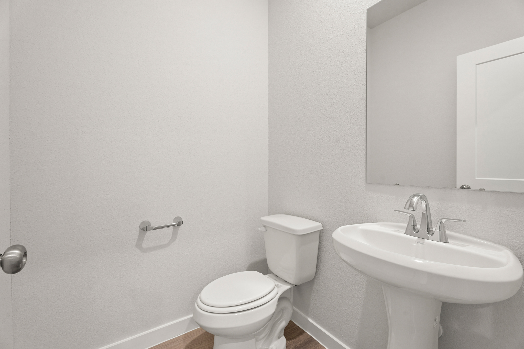 A bathroom with a toilet and sink.