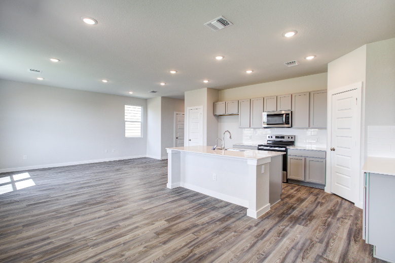 A kitchen with white cabinets.