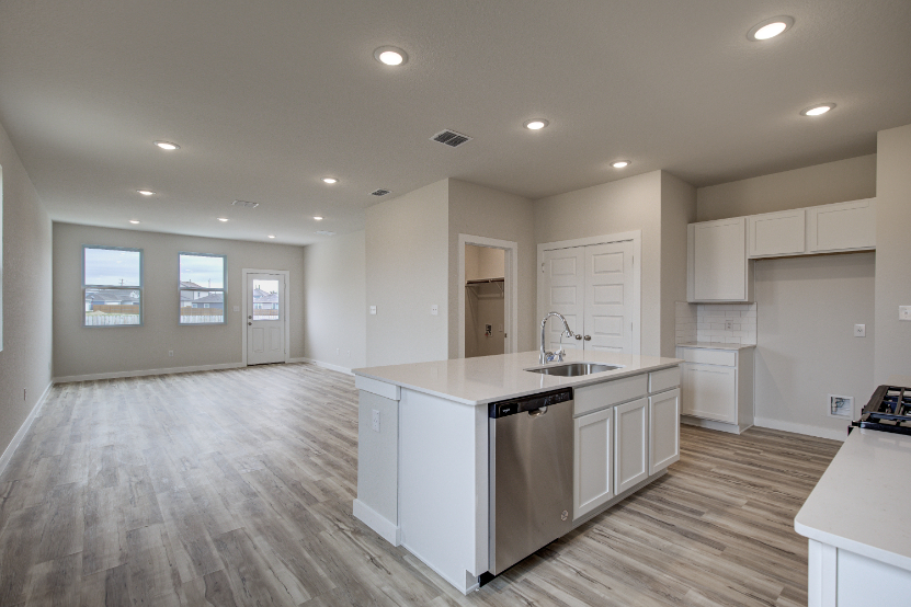 A kitchen with white cabinets.