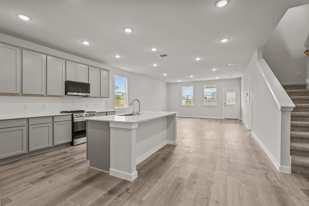 A kitchen with white cabinets.