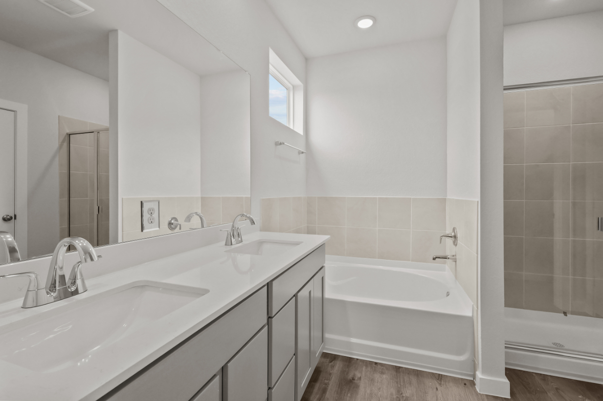 A bathroom with a tub sink and a bathtub.