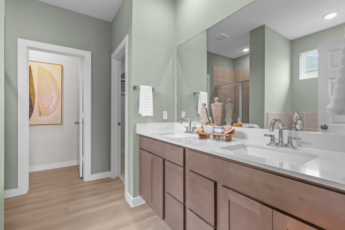 A bathroom with a large mirror.