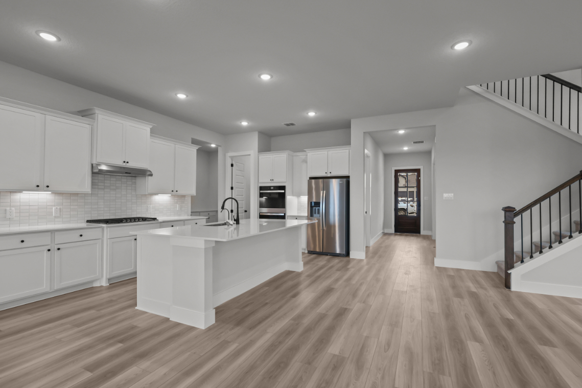A kitchen with white cabinets.