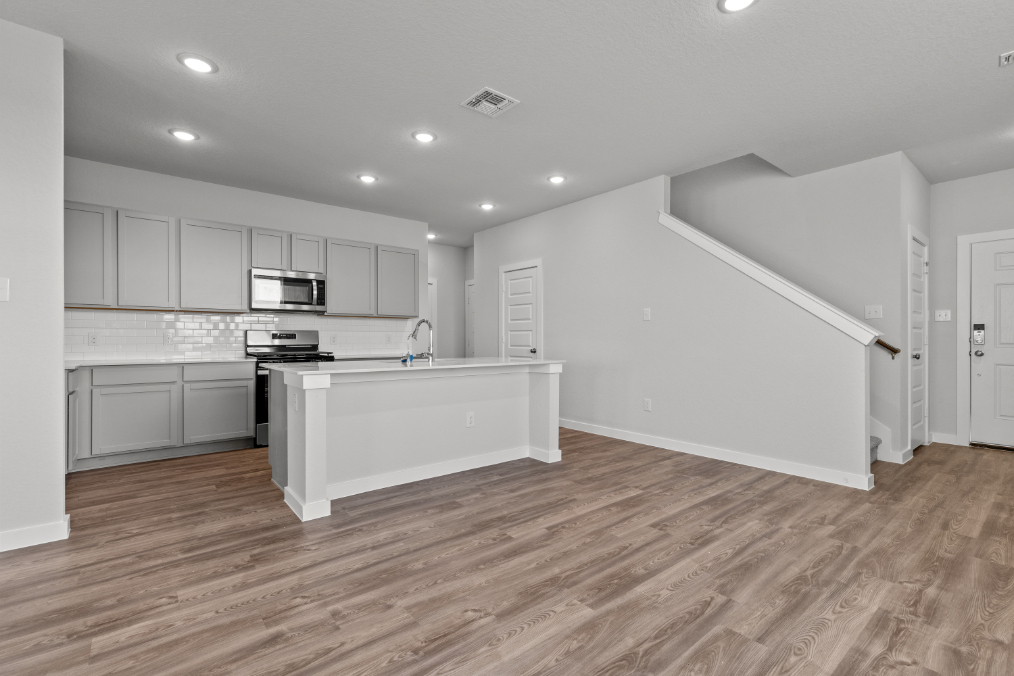 A kitchen with white cabinets.