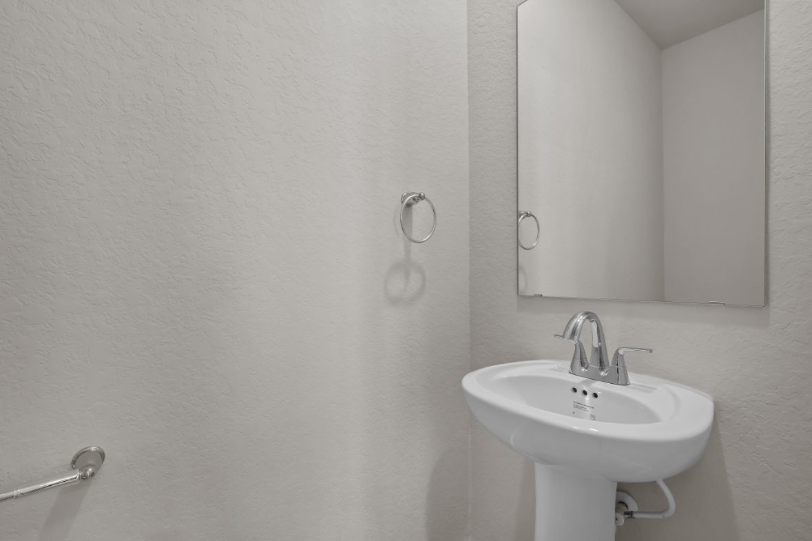 A bathroom with a sink and mirror.