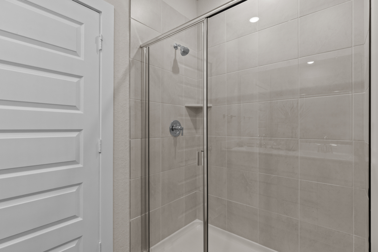 A shower with a glass door.