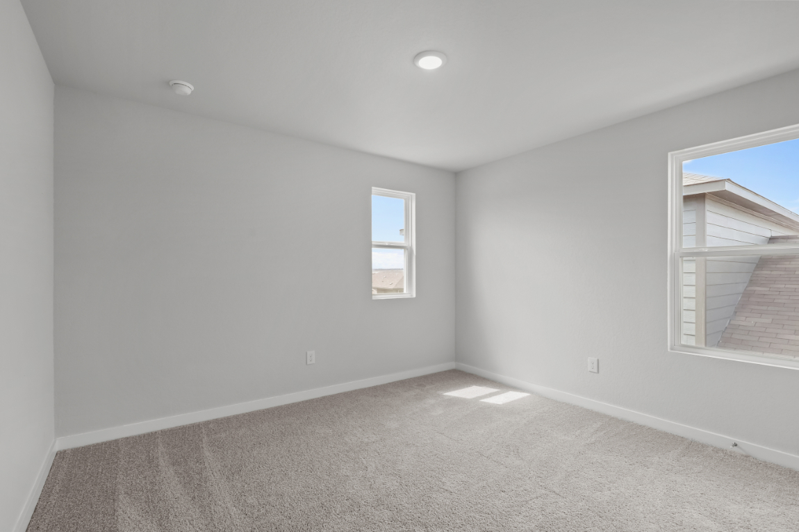 A room with a window and a carpet.