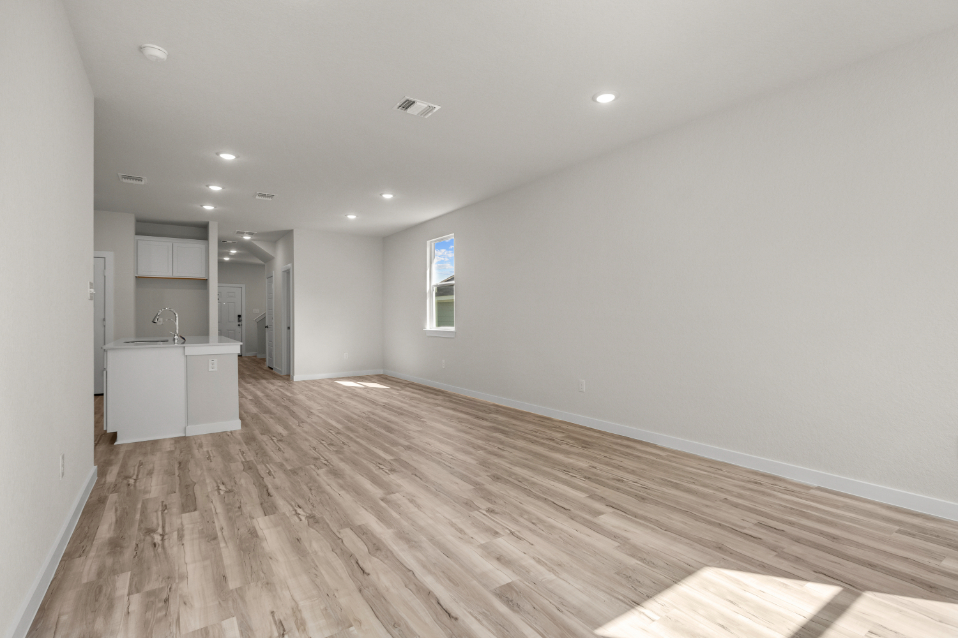 A room with a wood floor and white walls.