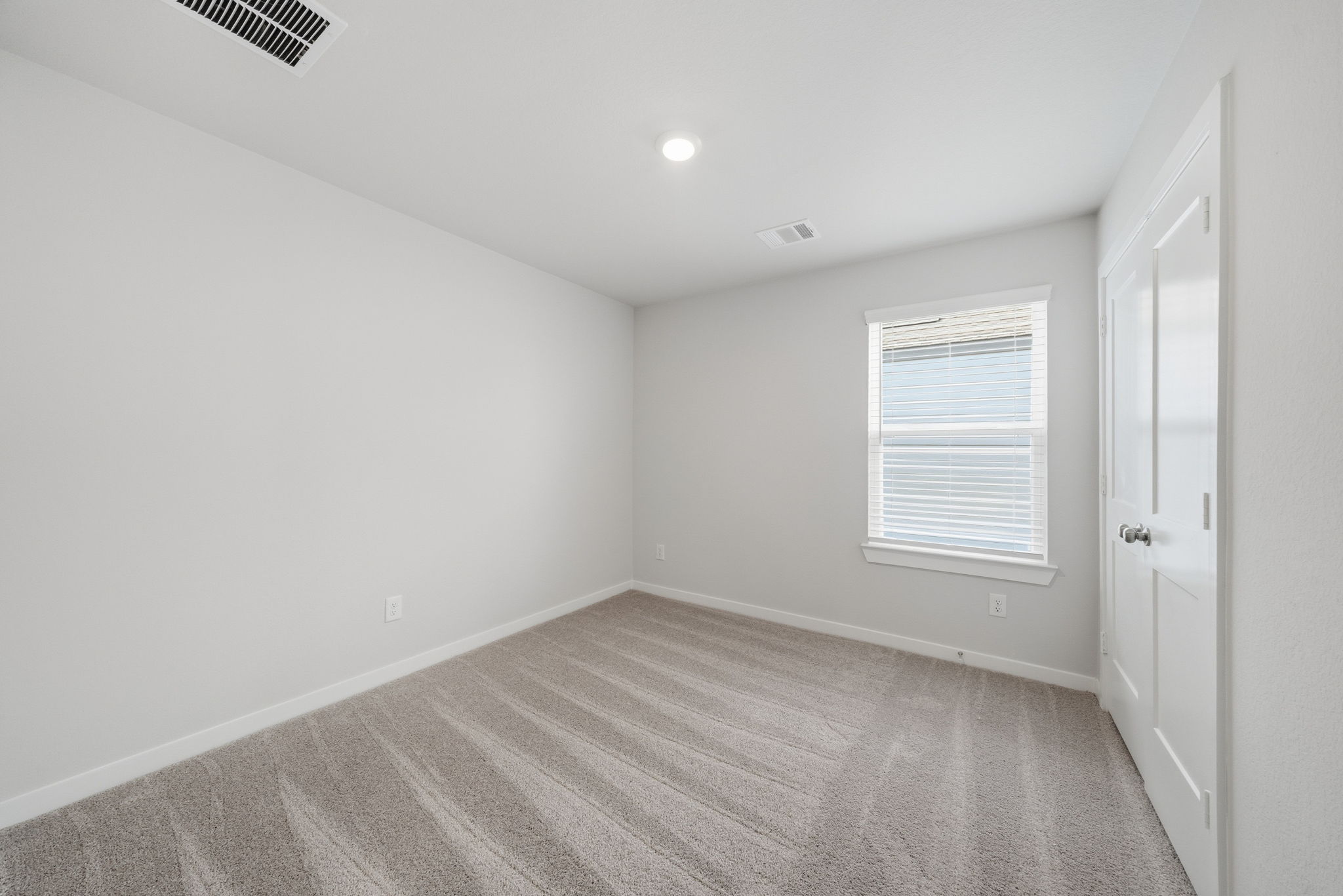 A room with white walls and a wood floor.