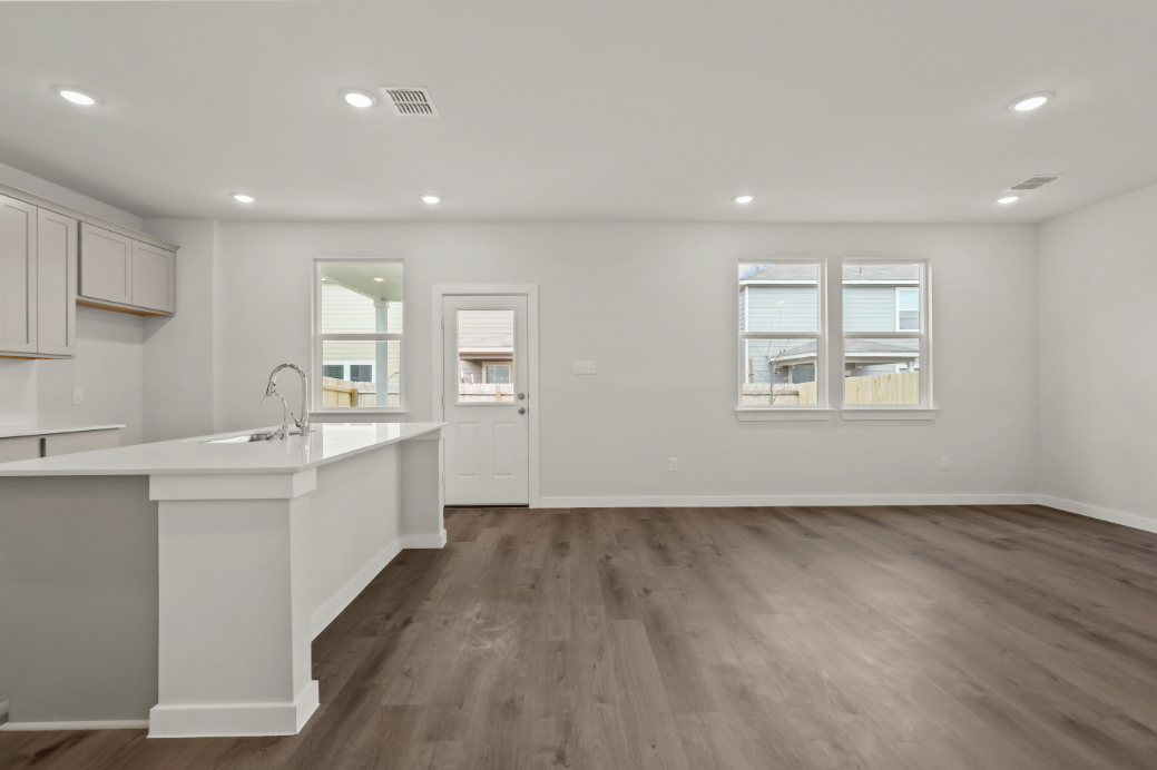 A kitchen with white cabinets.