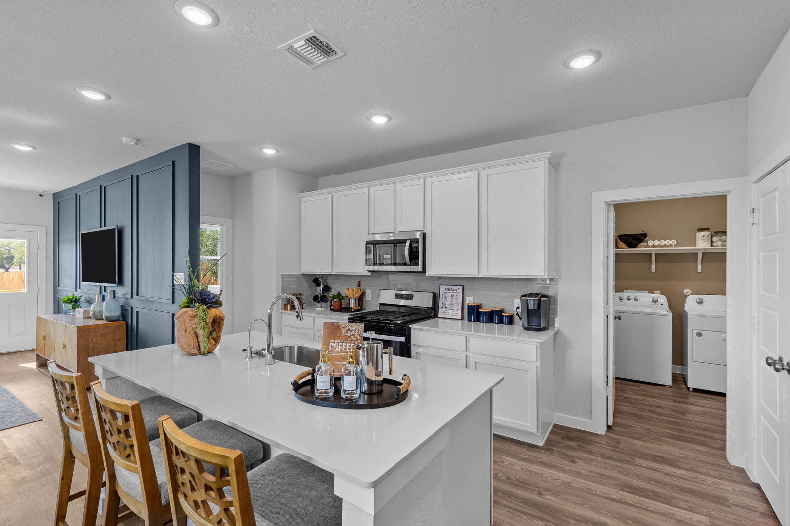 A kitchen with white cabinets.