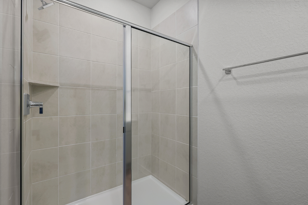 A shower with a glass door.