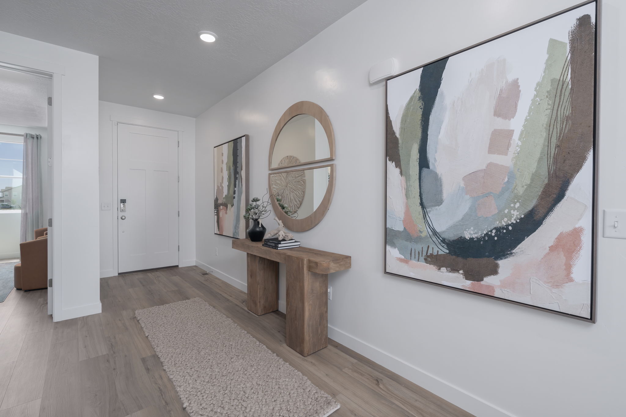 A room with a large painting on the wall.
