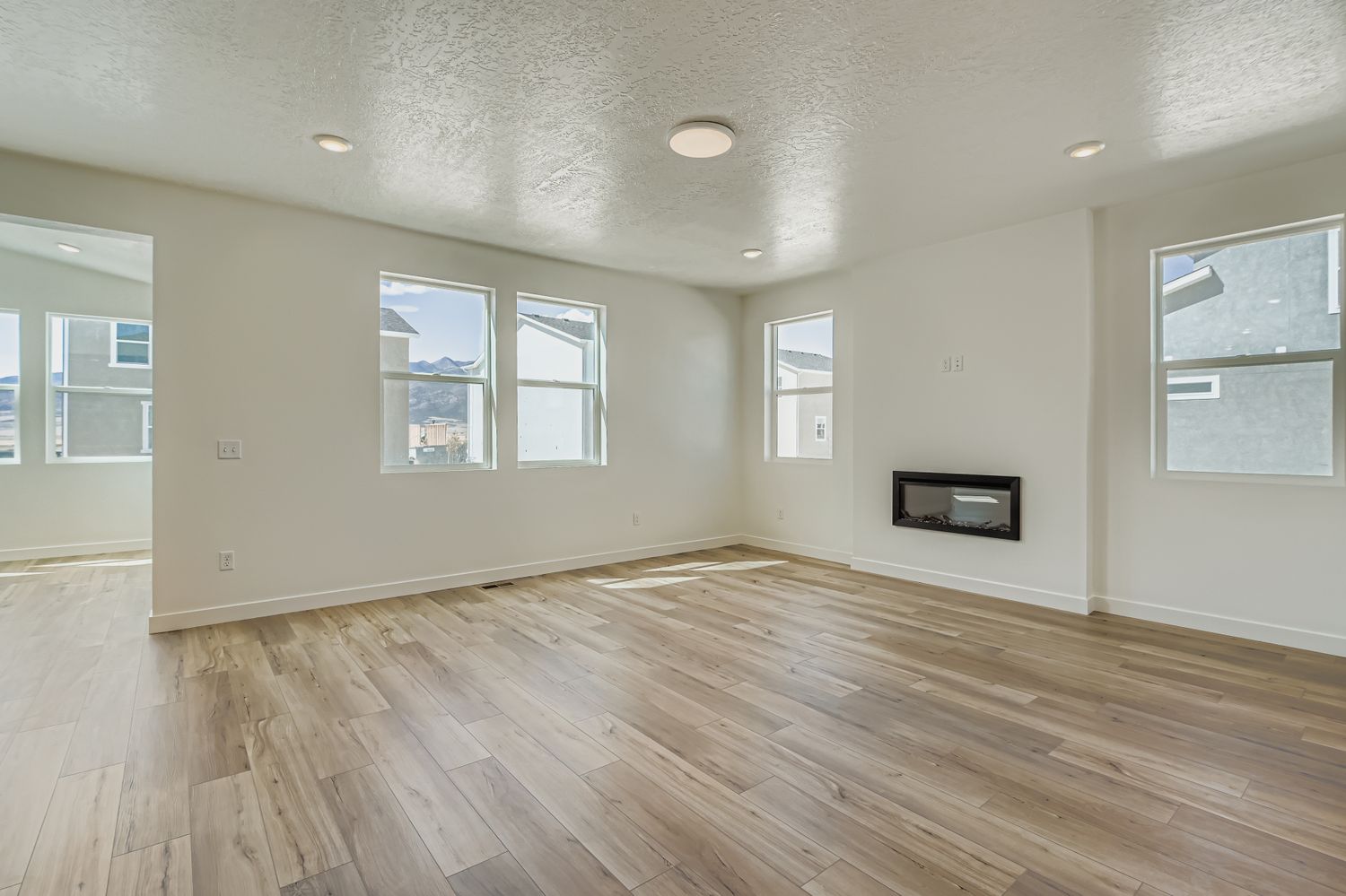 A room with a wood floor and windows.