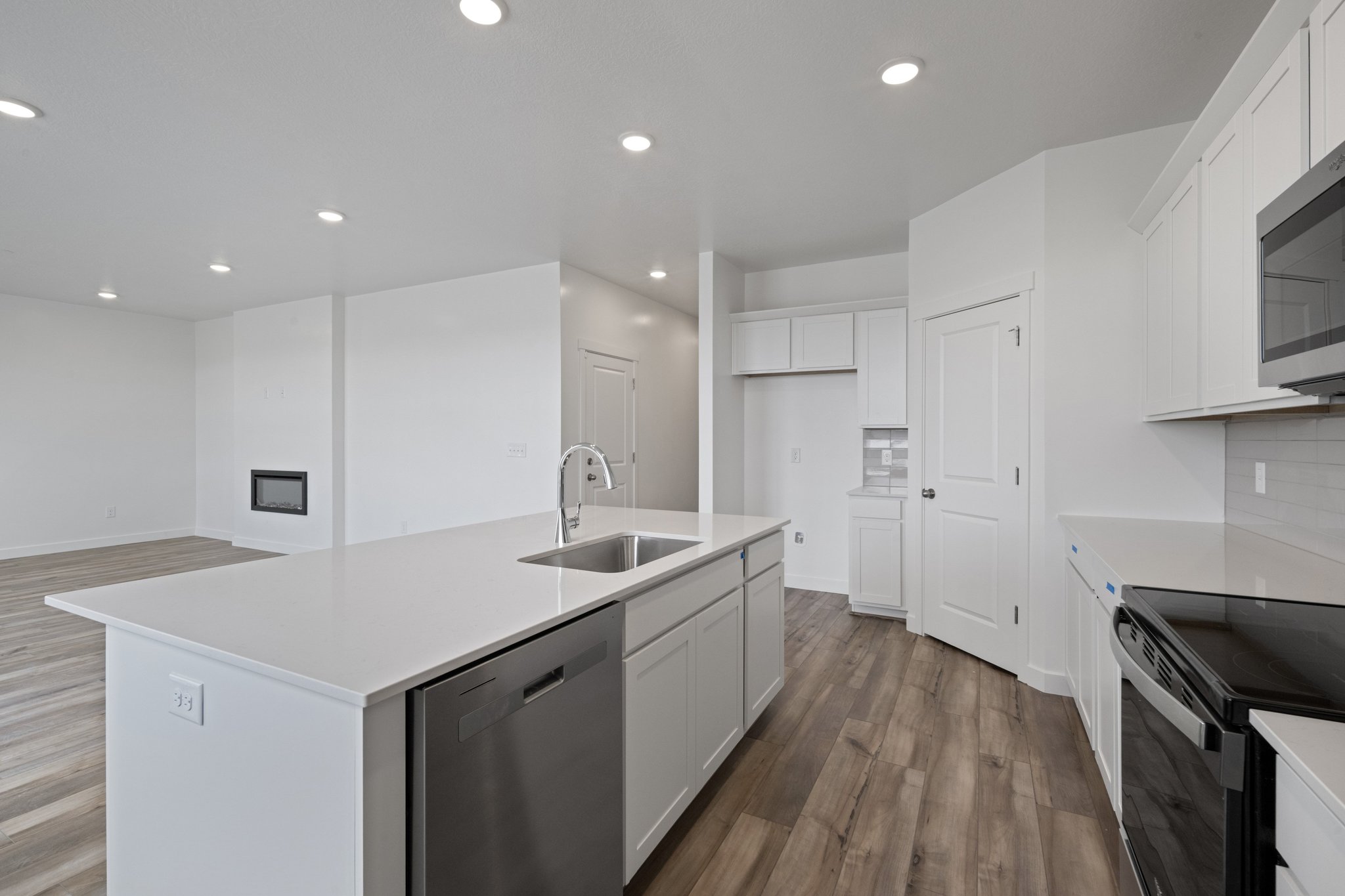 A kitchen with white cabinets.