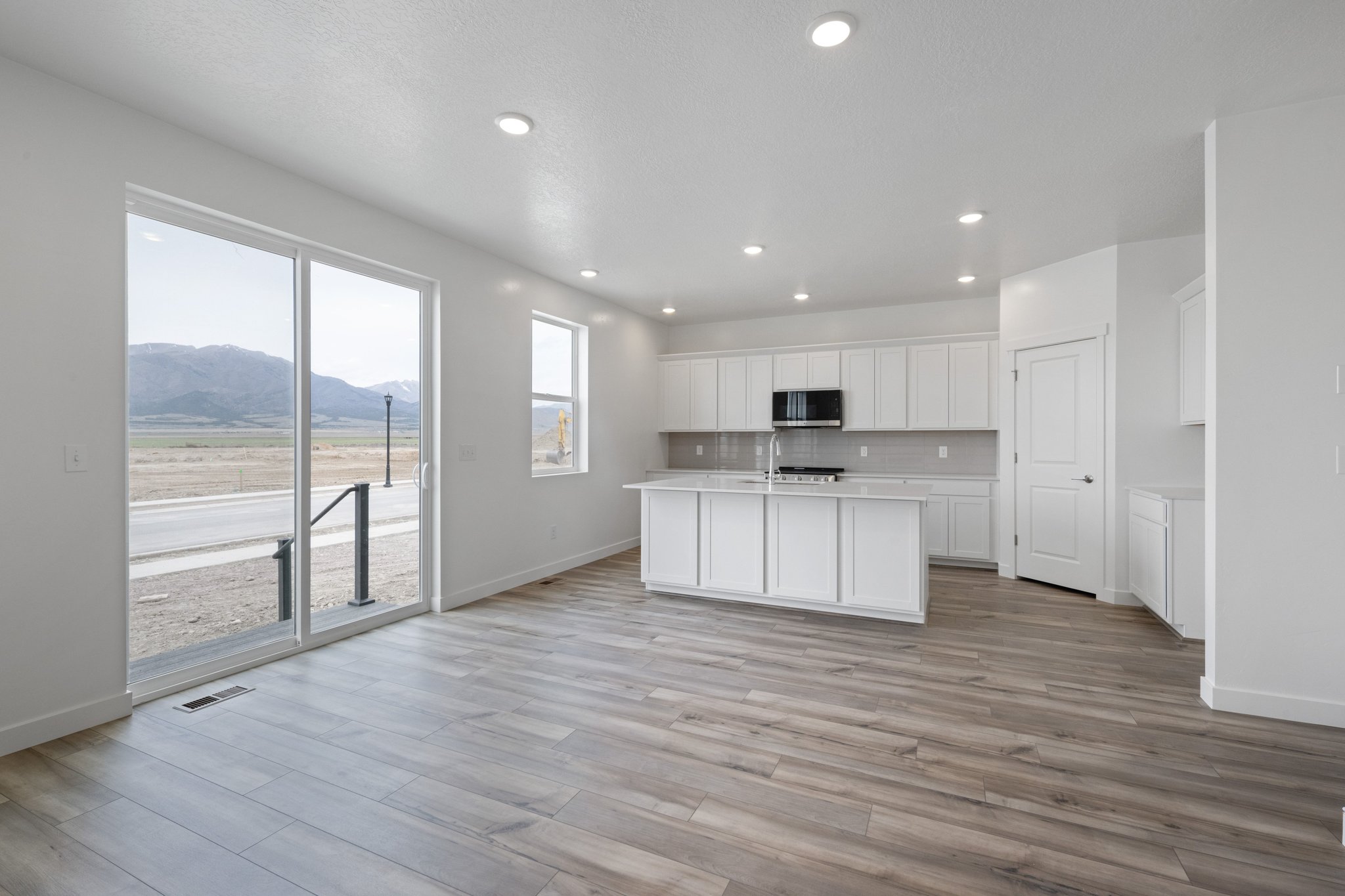 A kitchen with a large glass door.