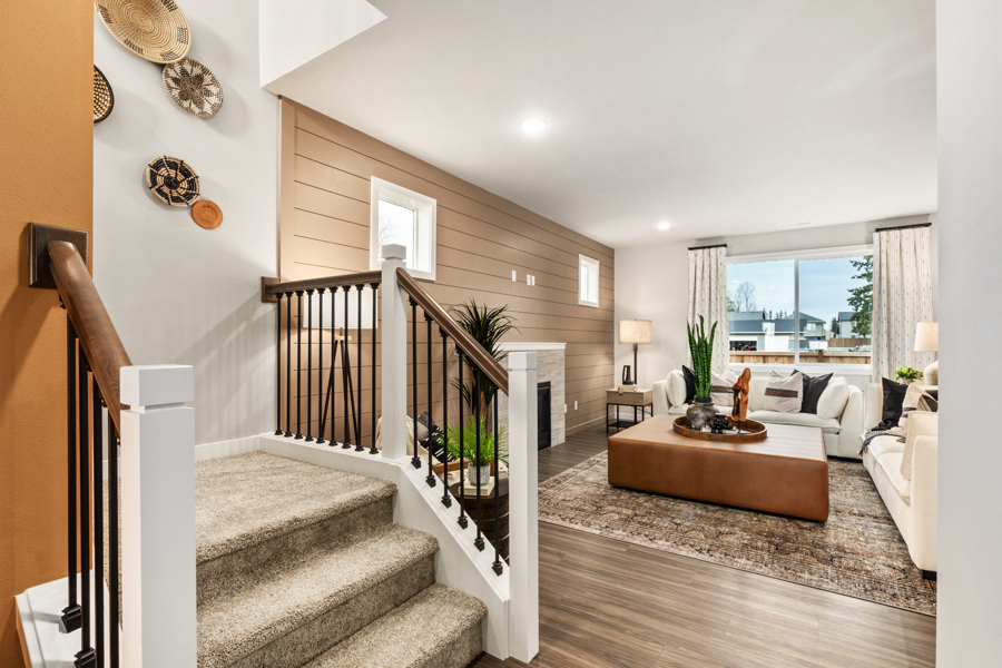 A large living room with a large staircase.