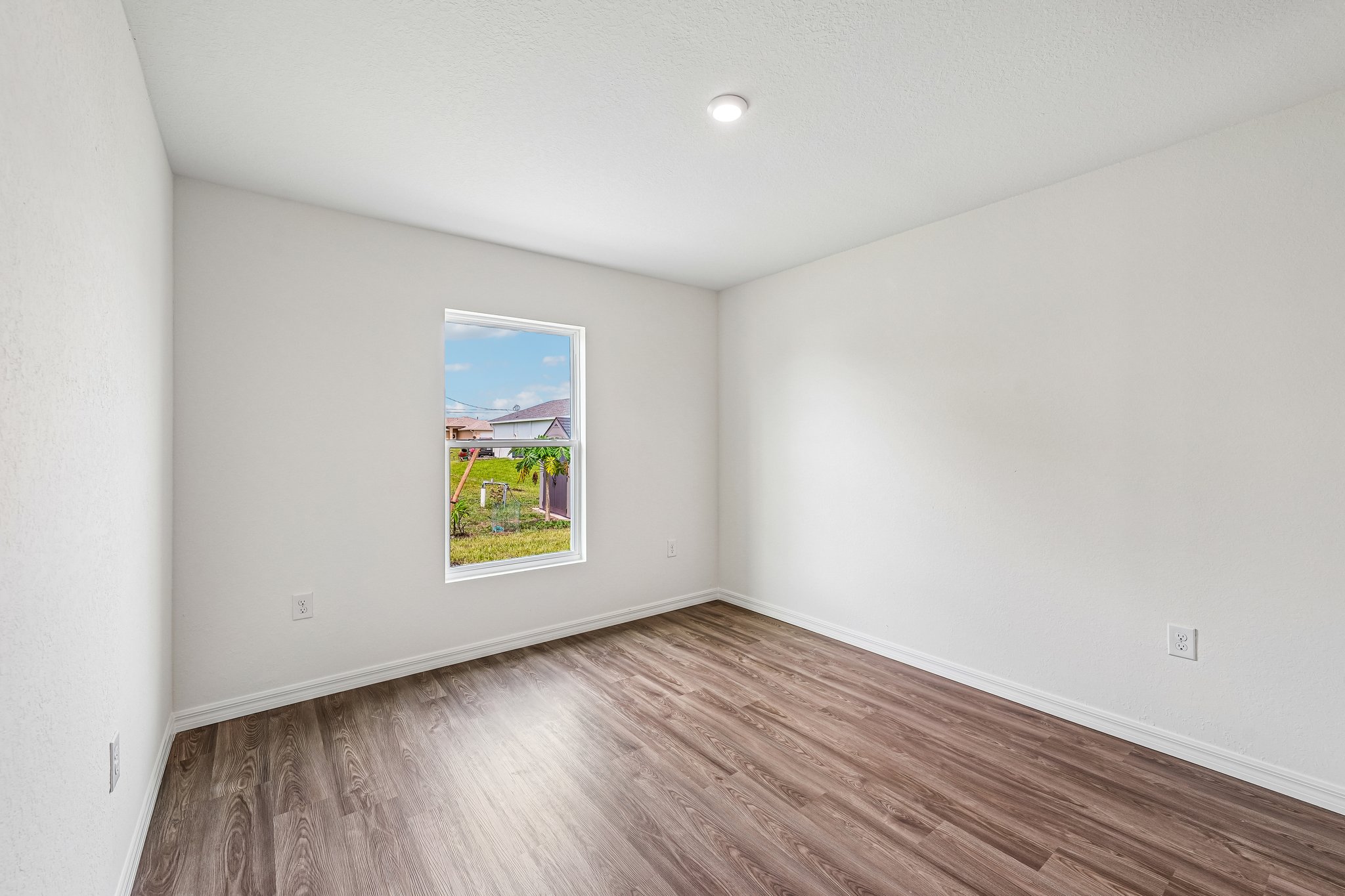 A room with a painting on the wall.
