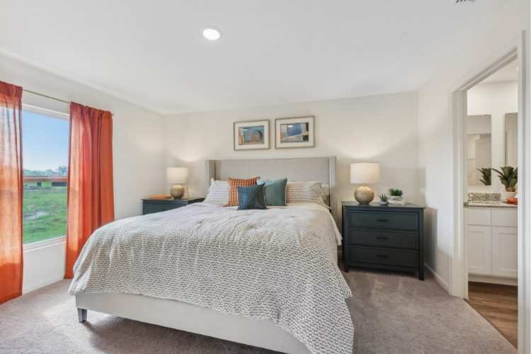 A bedroom with a large window.
