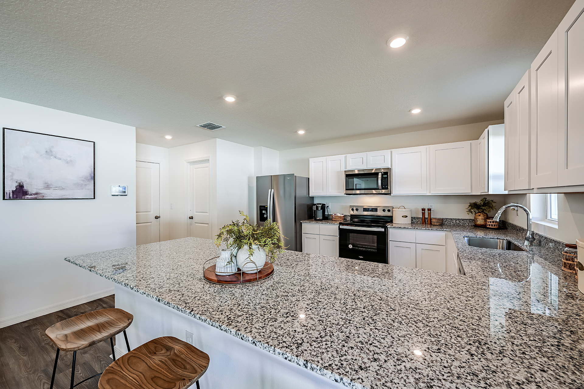 A kitchen with marble counters.
