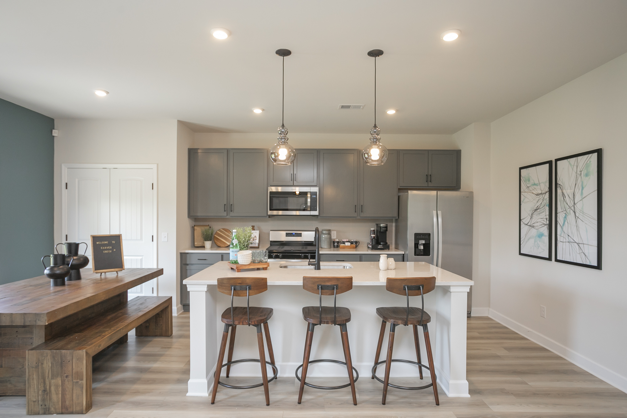 A kitchen with a bar and stools.
