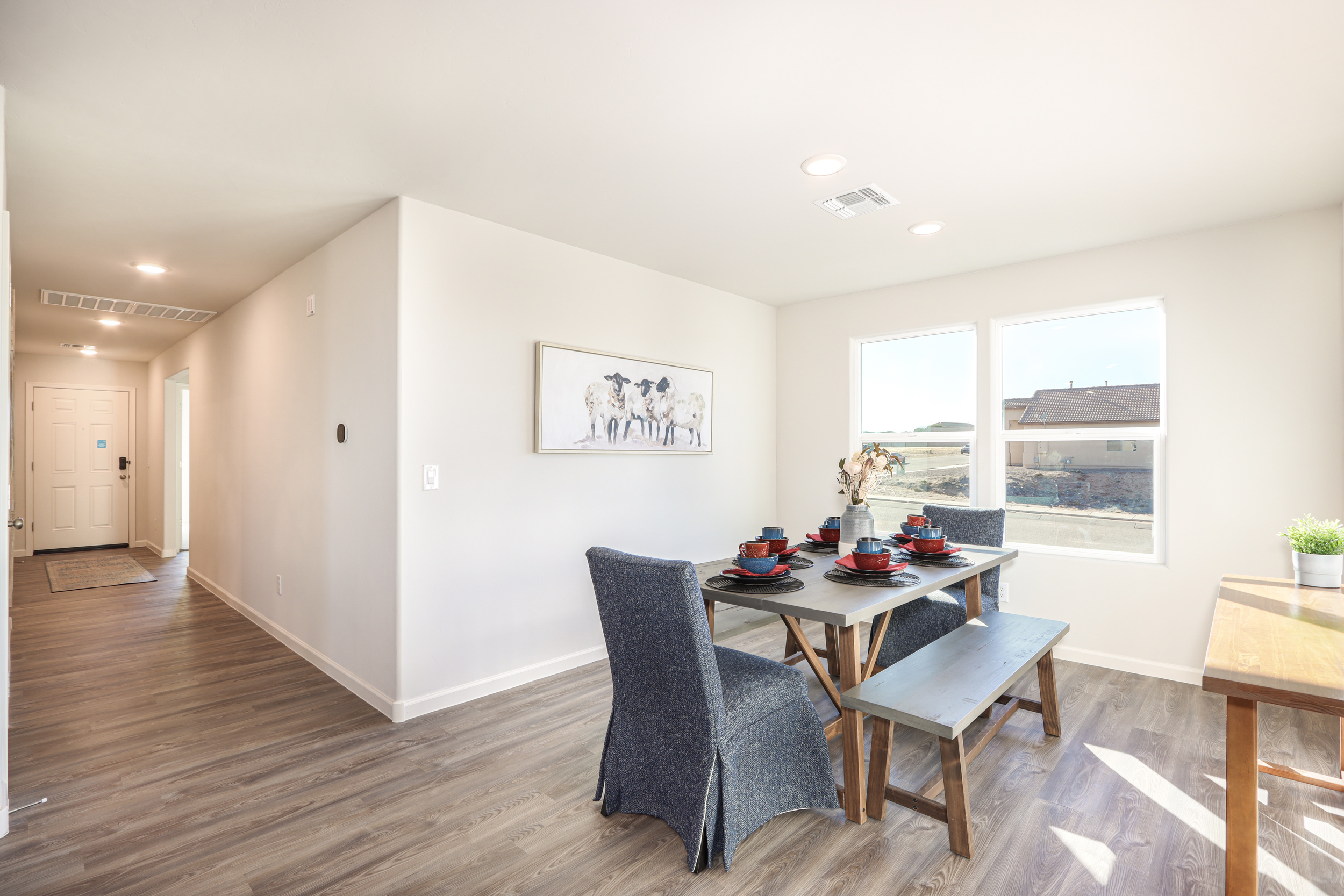 A room with a table chairs and a window.