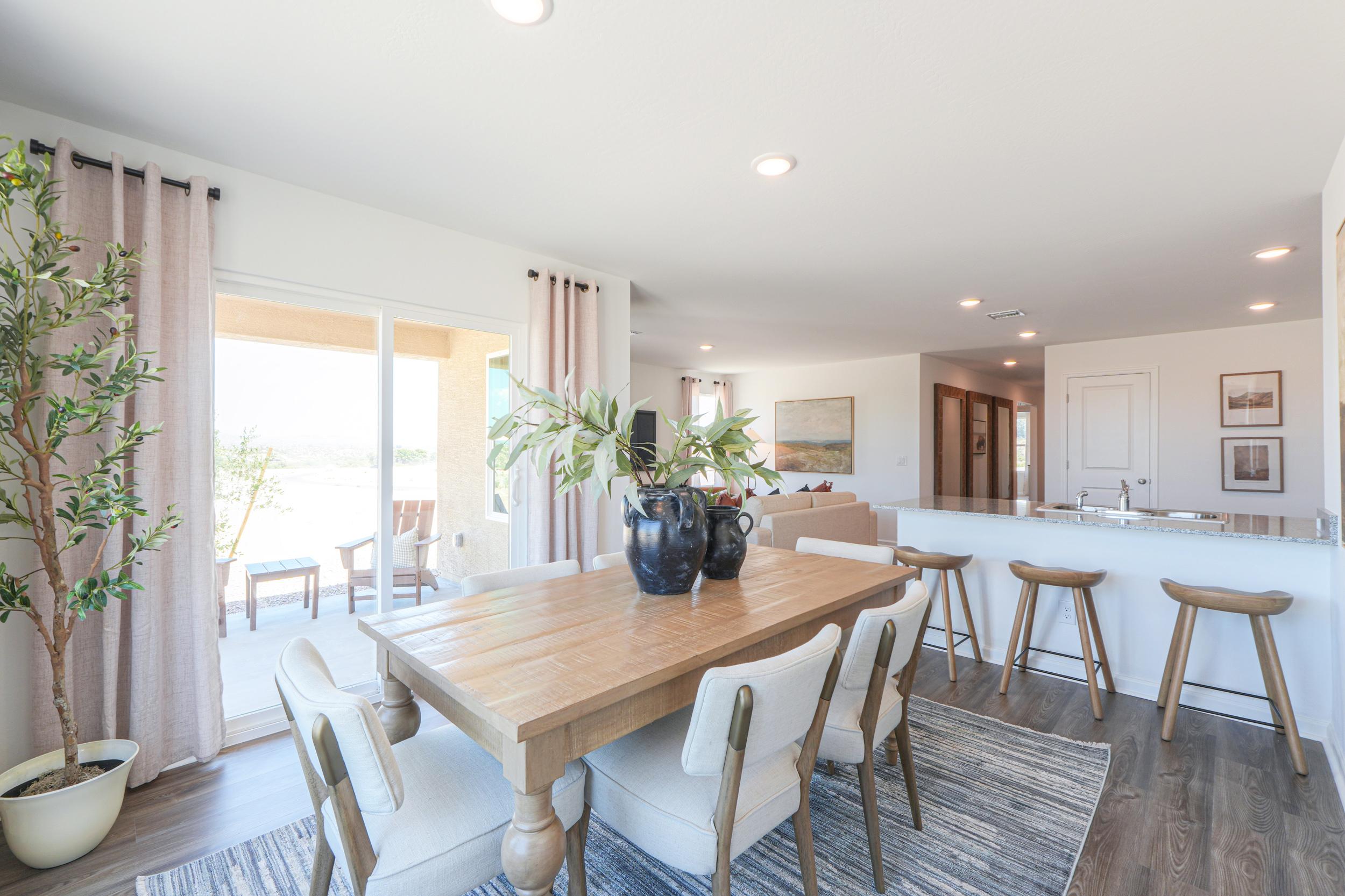 A dining room with a table and chairs.