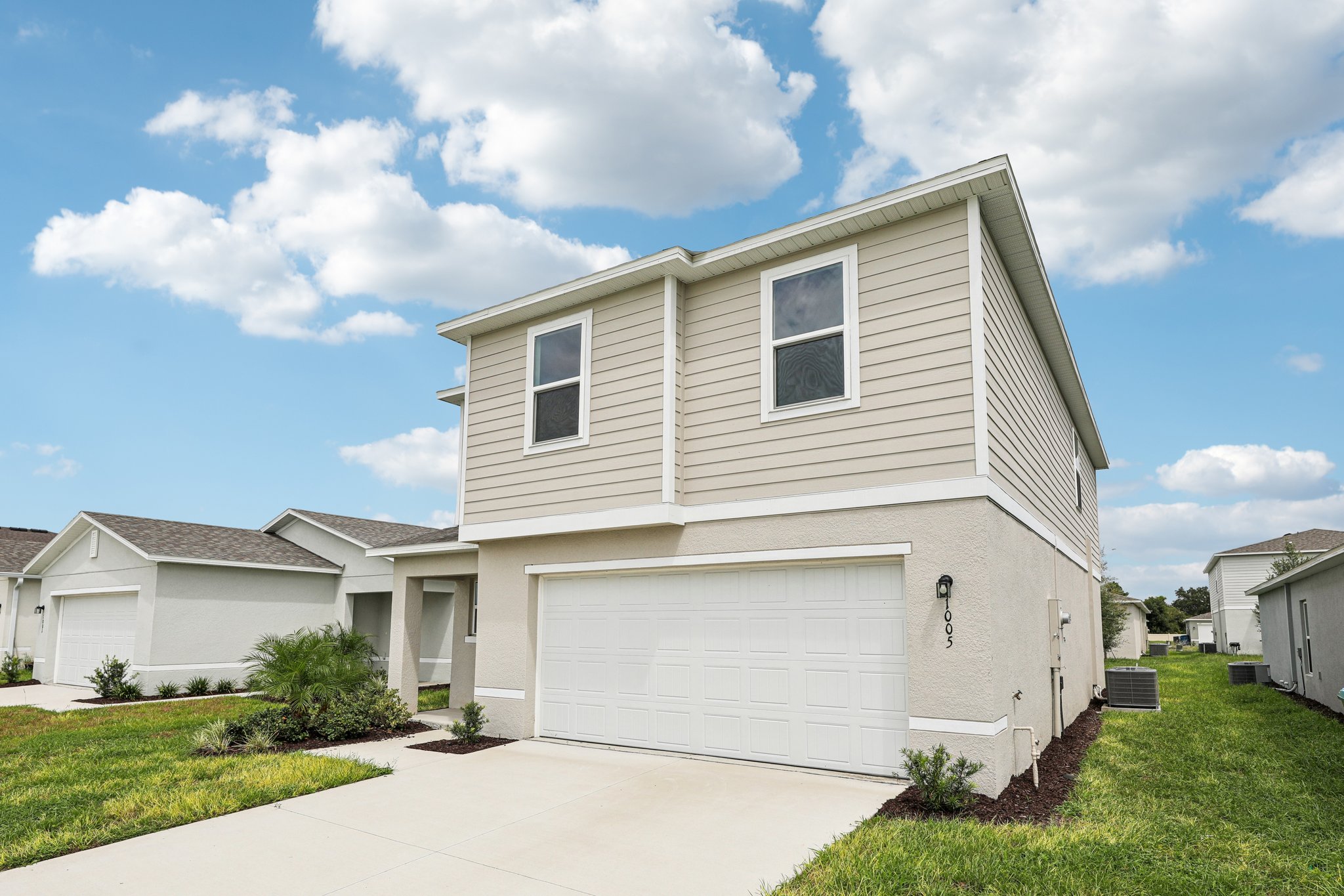 A white house with a garage.