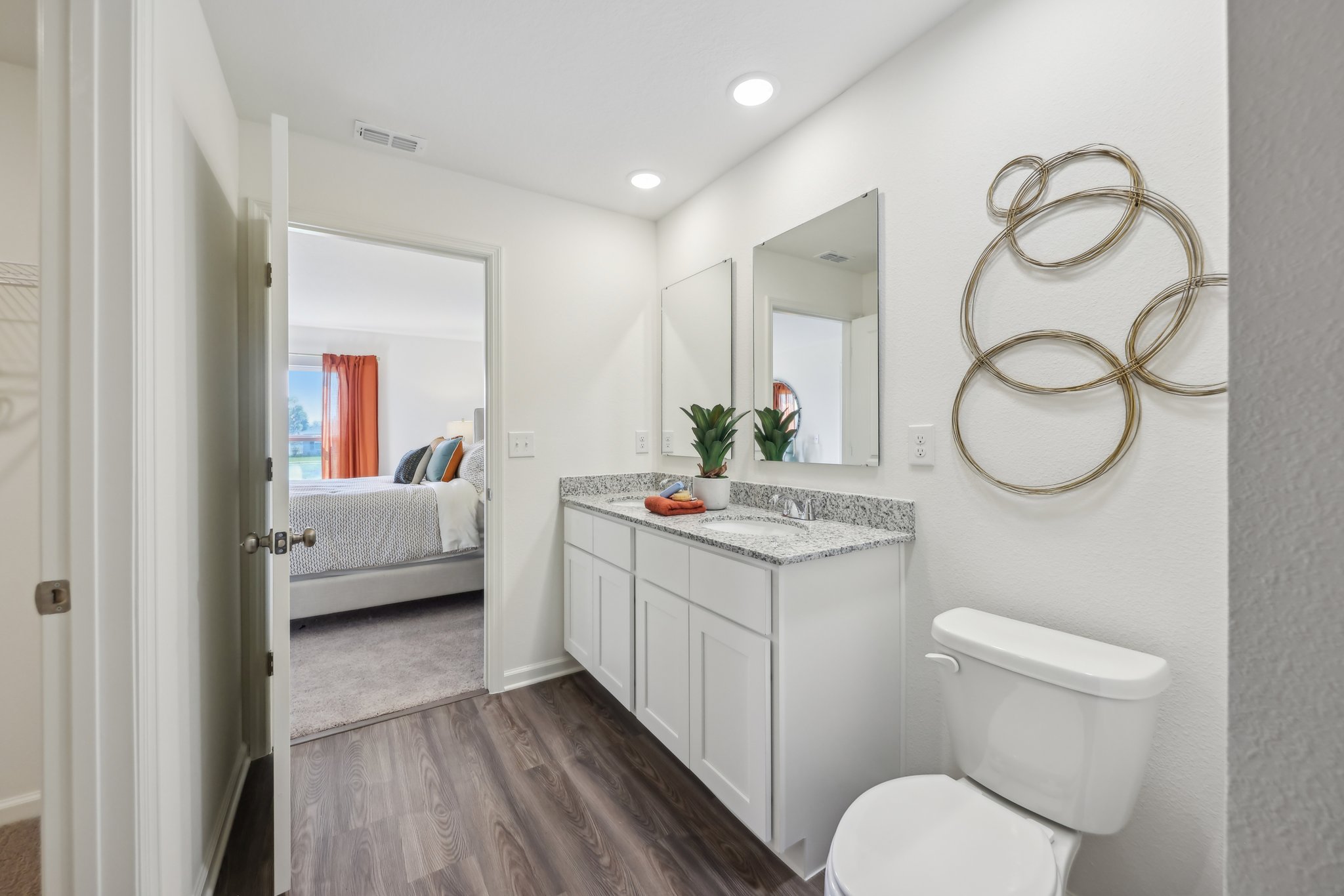 A bathroom with a bed and a sink.