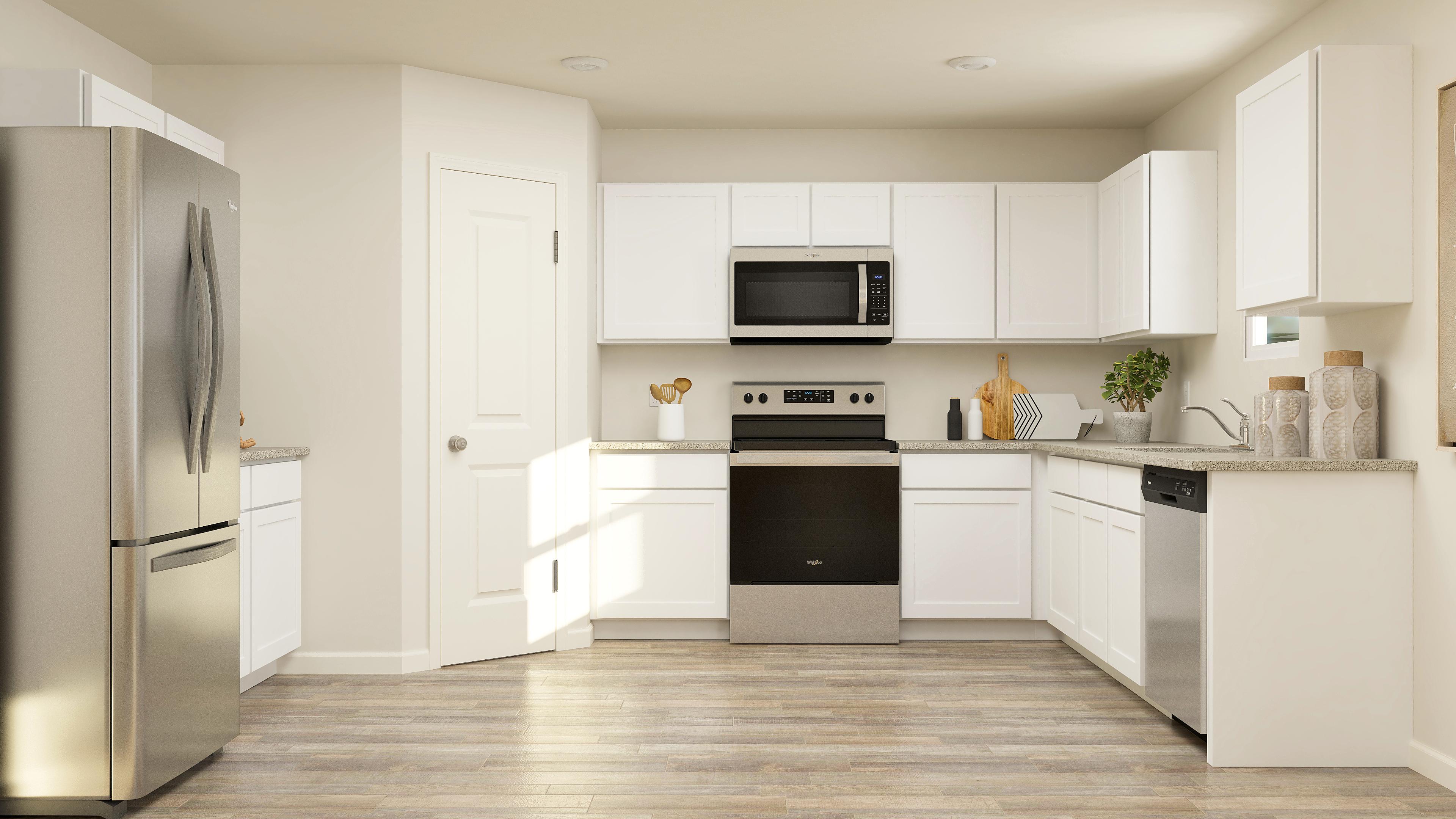 A kitchen with white cabinets.