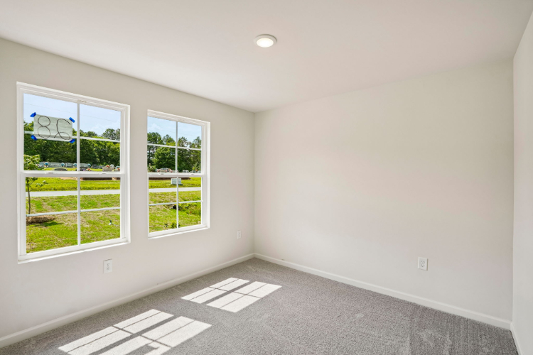 A room with windows and a tile floor.