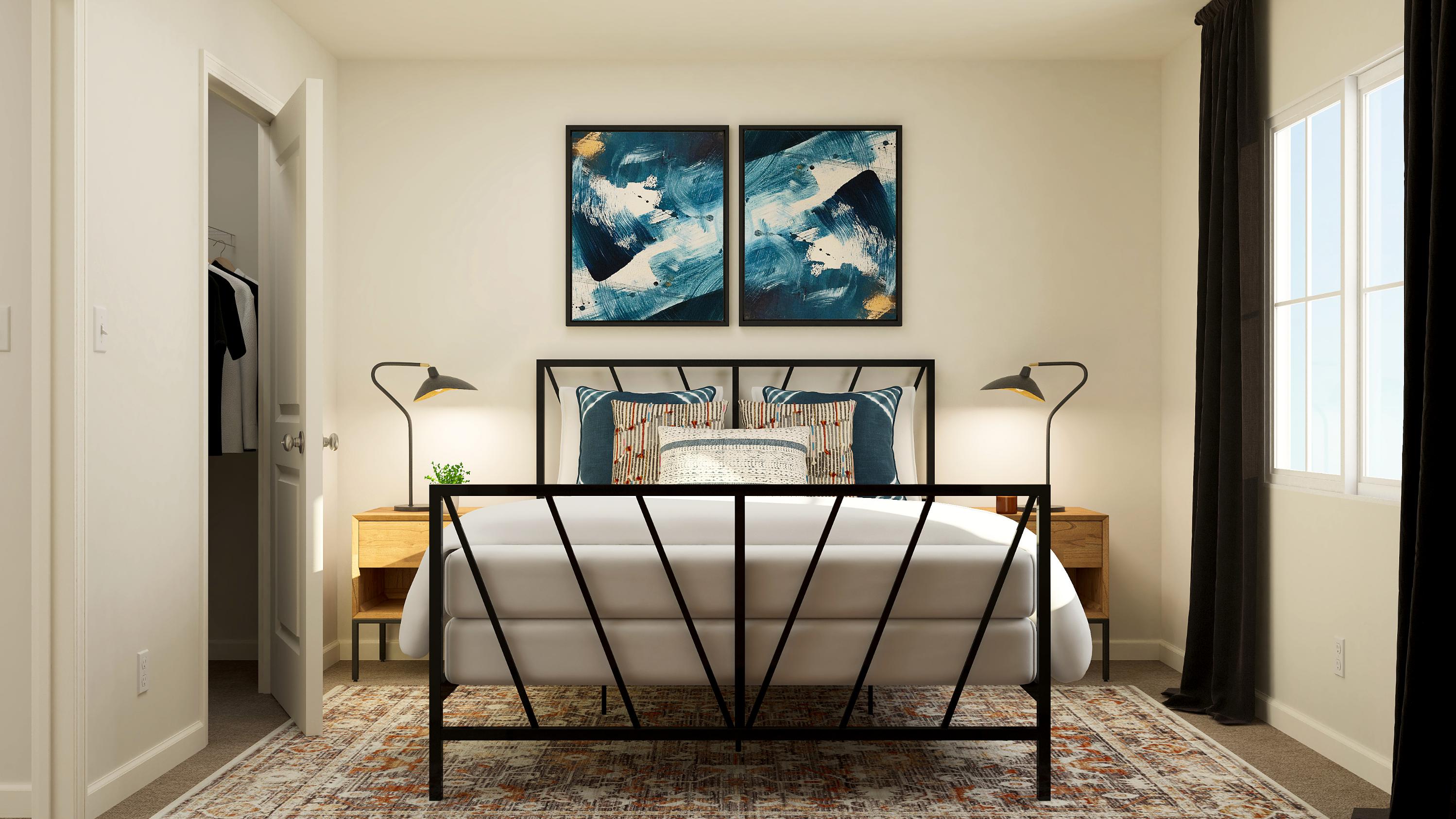 A room with a table and a lamp and a painting on the wall.