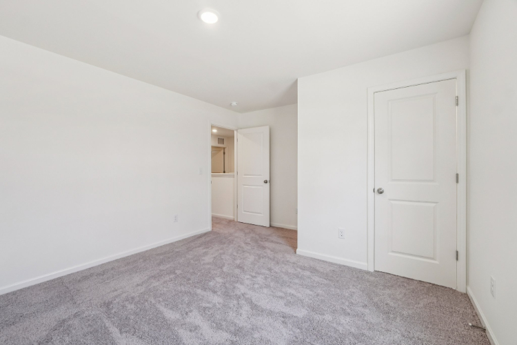 A hallway with white doors.