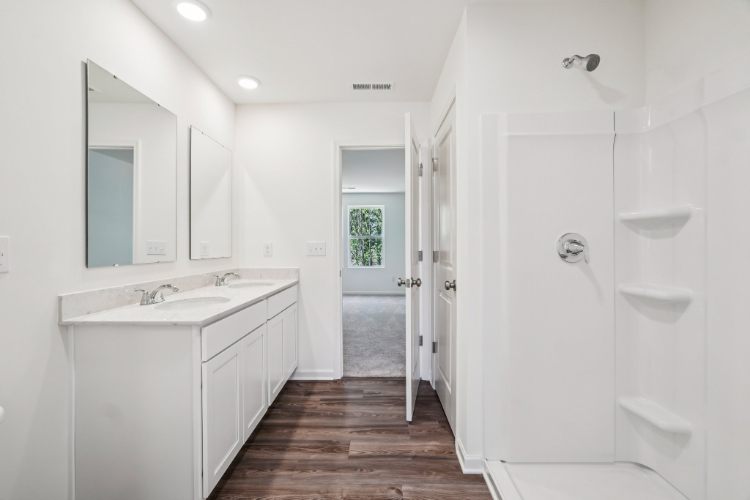 A bathroom with white walls.