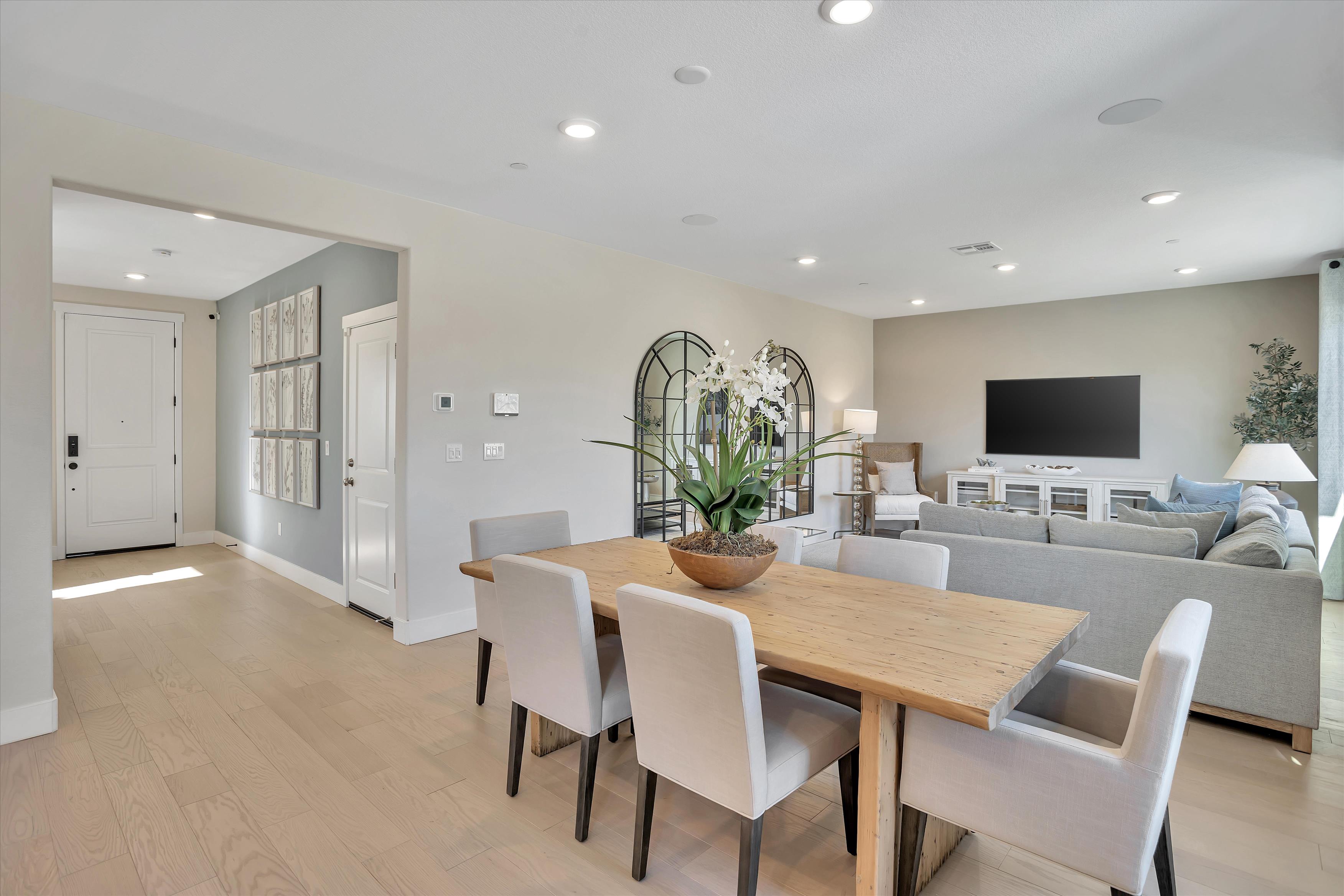 A large living room with a large table and chairs.