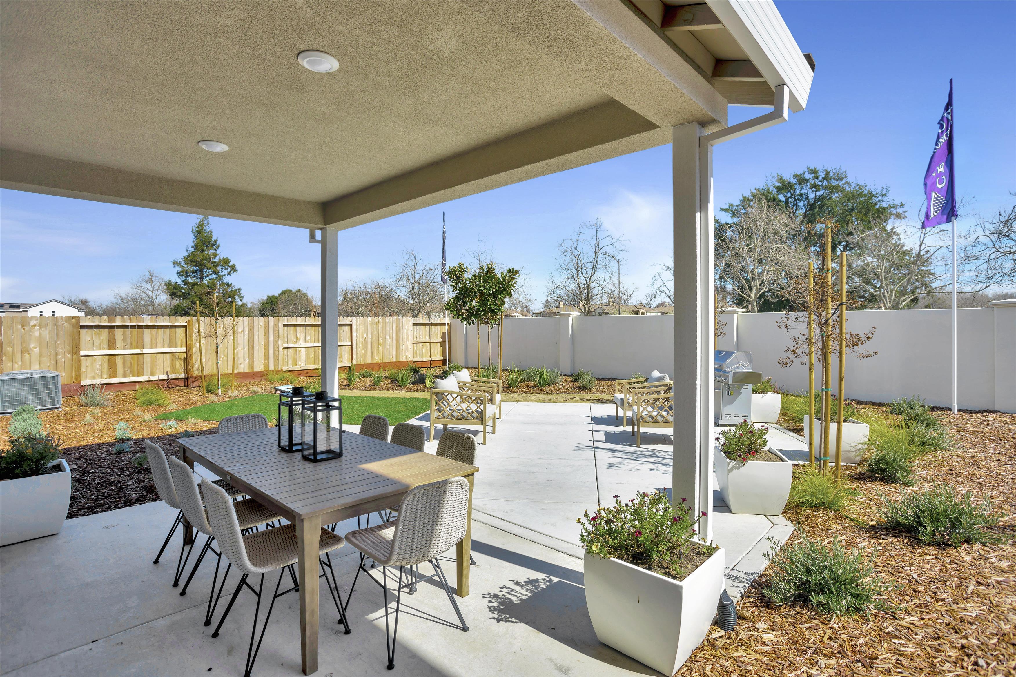 A patio with a table and chairs.