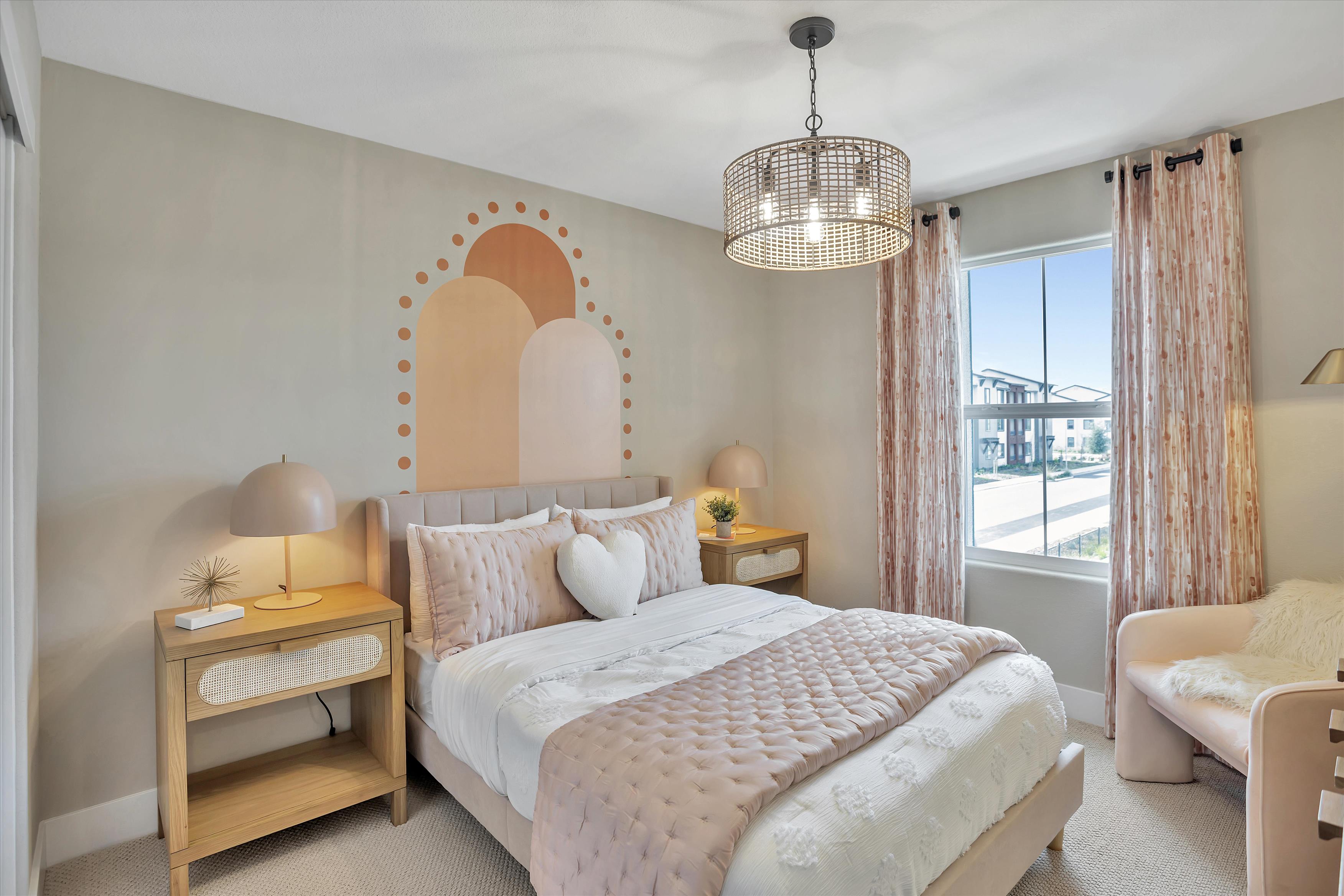 A bedroom with a large mirror.