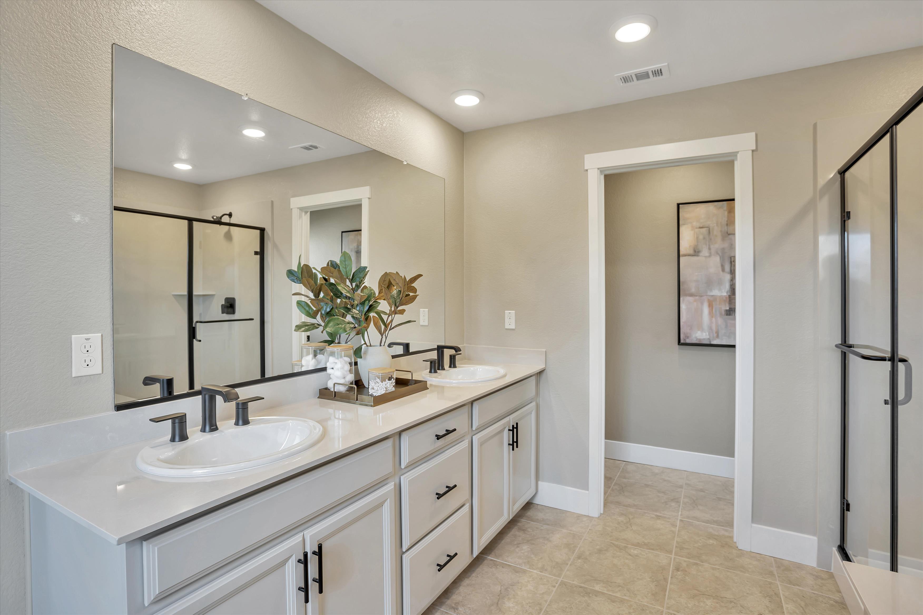 A bathroom with a large mirror.